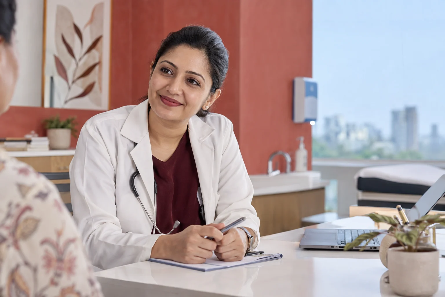 A doctor listening to a patient across a desk